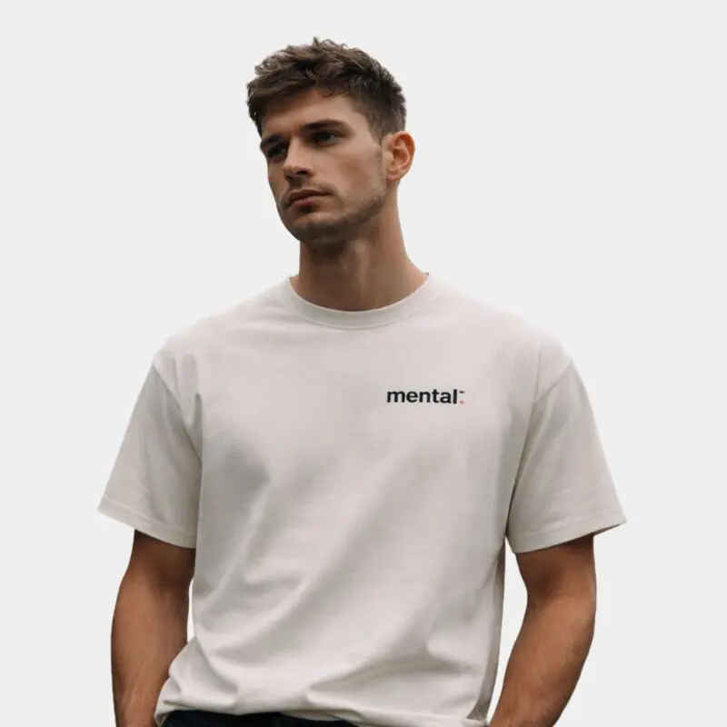 White t-shirt with 'mental:' logo, worn by a person.