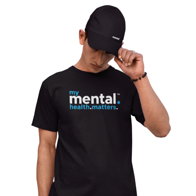 Person wearing mental health awareness shirt and cap.